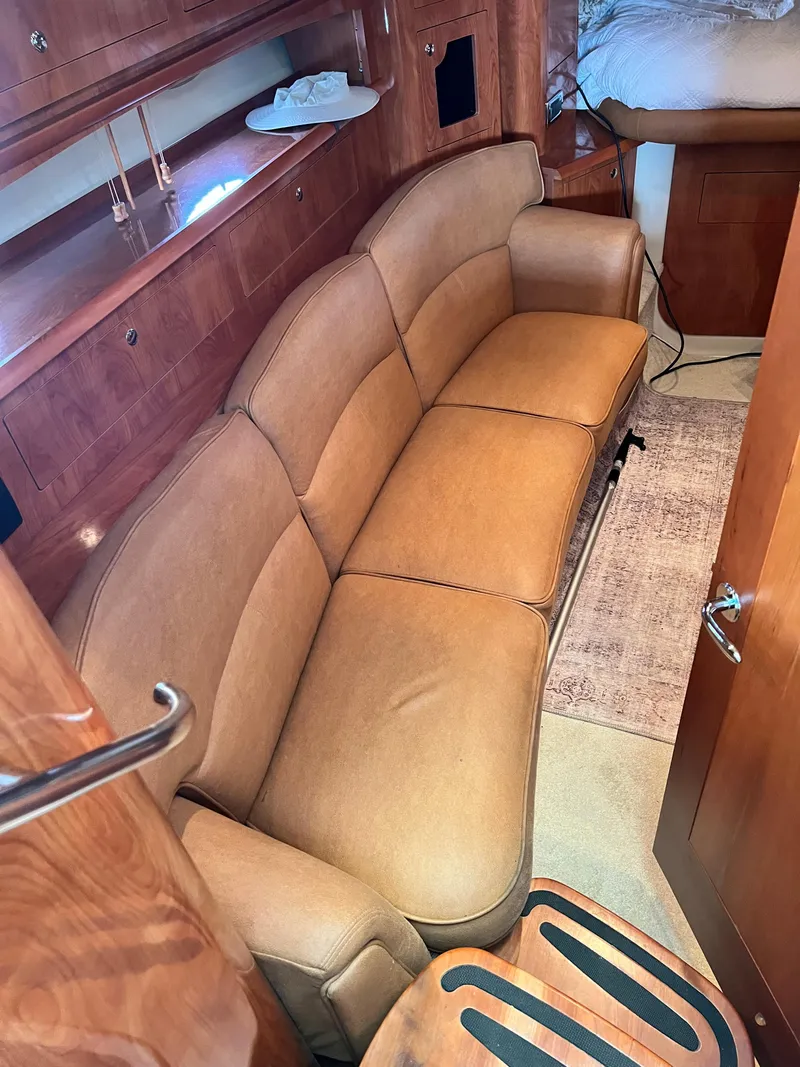 Slide: The Image of 2007 Four Winns 358 Vista interior with tan leather sofa and wooden cabinetry. - 18