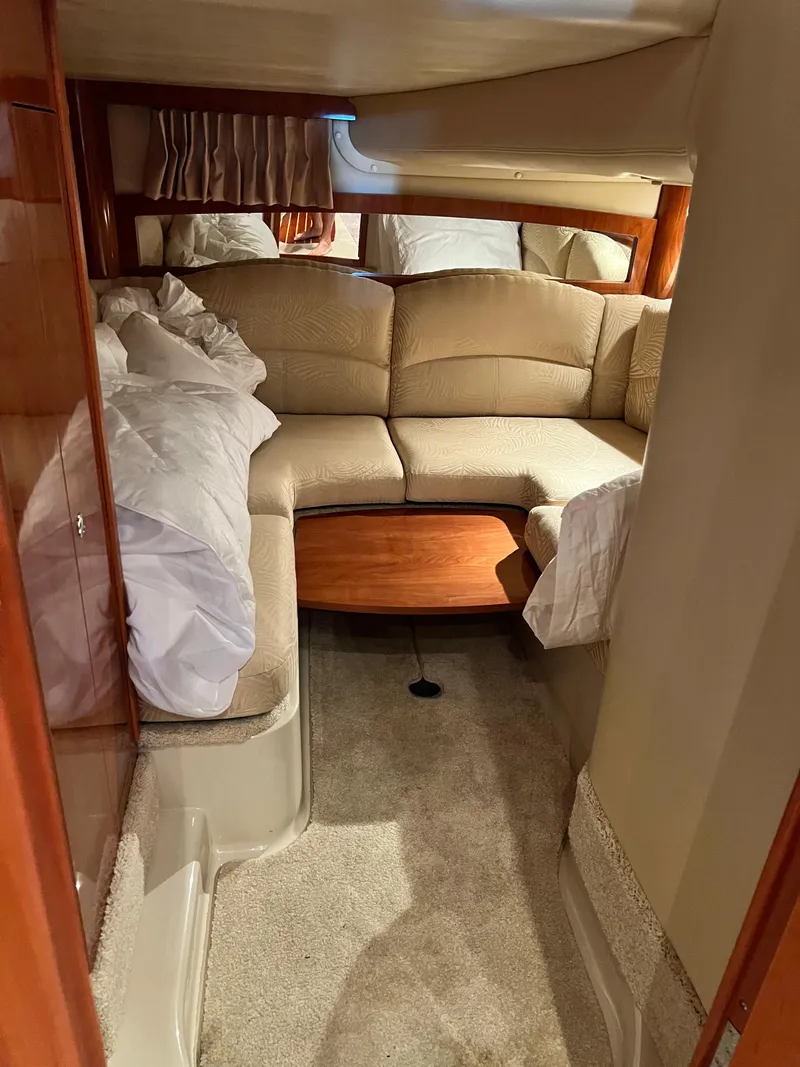 Slide: The Image of 2007 Four Winns 358 Vista cabin interior with beige seating and wooden table. - 19