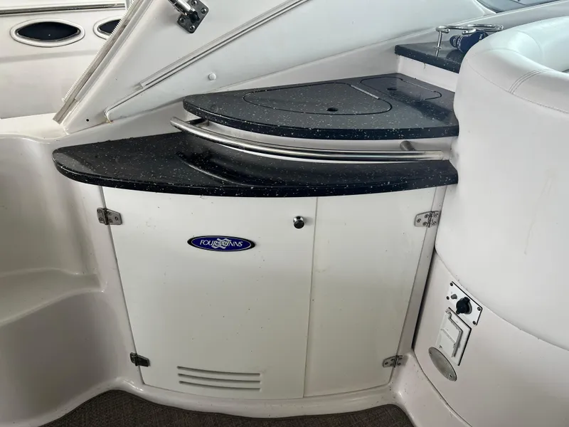 Slide: The Image of 2007 Four Winns 358 Vista boat interior with black countertop and white cabinetry. - 6