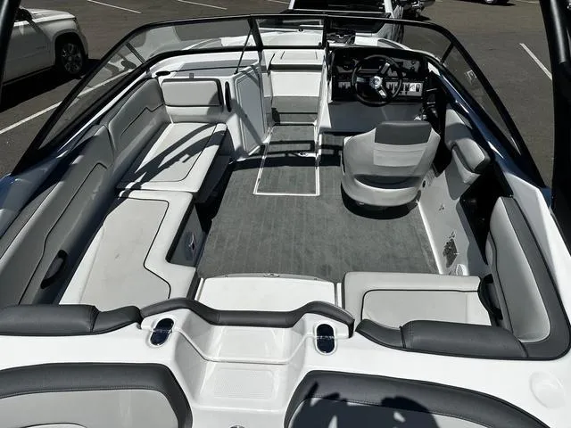 Slide: The Image of 2023 Yamaha Boats AR190 interior, spacious seating, modern design, and sleek dashboard. - 7