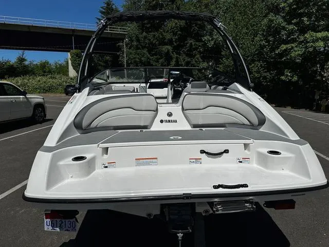 Slide: The Image of 2023 Yamaha Boats AR190 in a parking lot, rear view. - 9