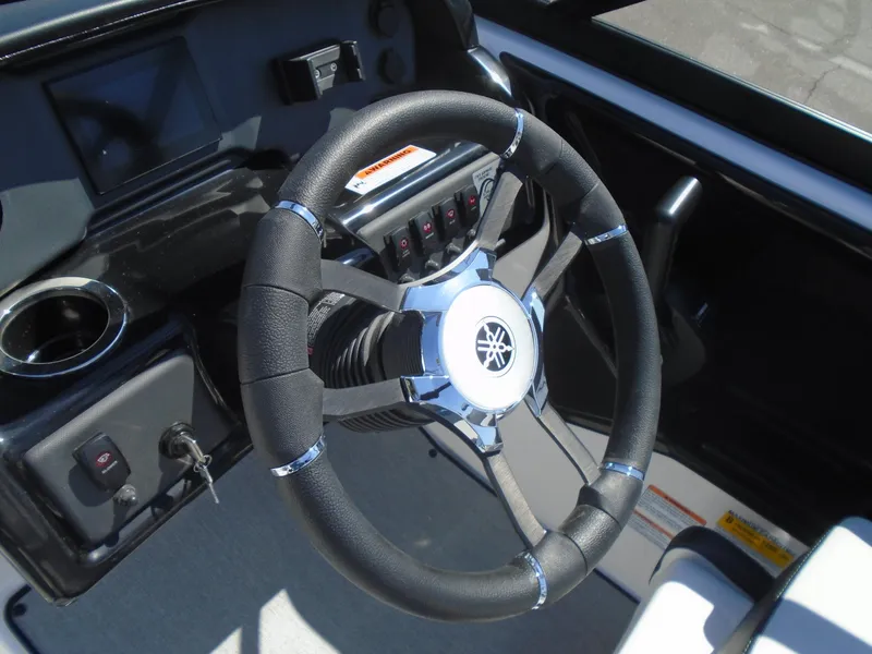 Slide: The Image of 2024 Yamaha SX195 boat steering wheel and dashboard close-up. - 11