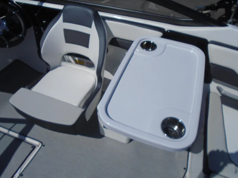 Slide: The Image of 2024 Yamaha Boats SX195 interior with seating and table featuring cup holders. - 12