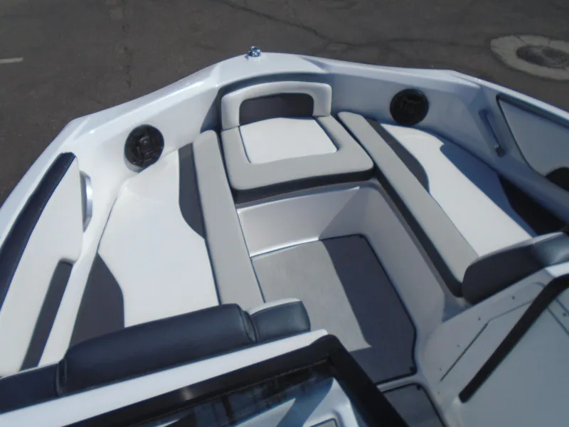 Slide: The Image of 2024 Yamaha Boats SX195 interior seating, white and gray upholstery, spacious and modern design. - 9