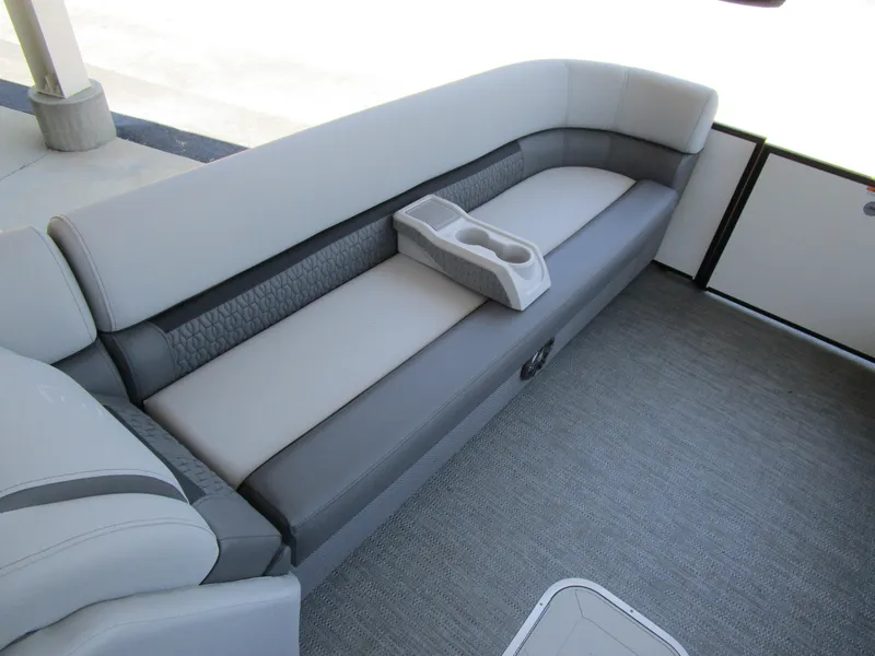 Slide: The Image of 2024 Sweetwater Entertainment SW 2286 MT boat interior seating with cup holders. - 11