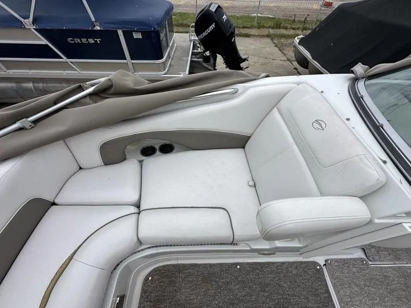 Slide: The Image of 2012 Crownline E1 boat interior with white cushioned seating. - 10