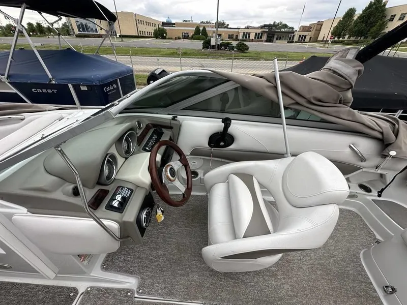 Slide: The Image of 2012 Crownline E1 boat interior with steering wheel and captain's chair. - 12
