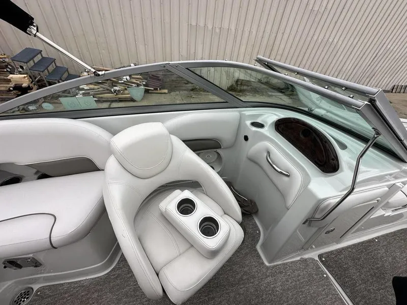 Slide: The Image of 2012 Crownline E1 boat interior with white leather seats and cup holders. - 14