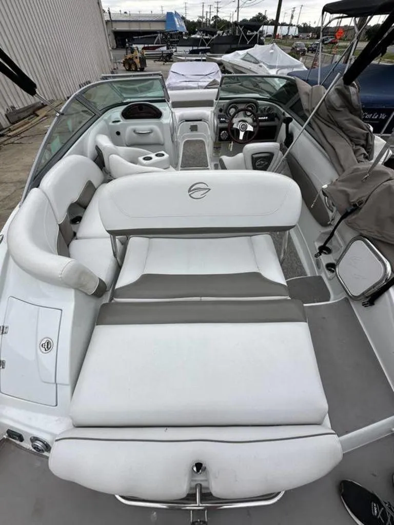 Slide: The Image of 2012 Crownline E1 boat interior with white and gray seating, steering wheel, and dashboard. - 3