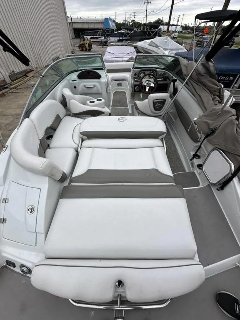 Slide: The Image of 2012 Crownline E1 boat interior with white and gray seating, steering wheel, and dashboard. - 4