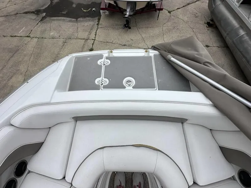 Slide: The Image of 2012 Crownline E1 boat interior with white seating and storage compartments. - 6