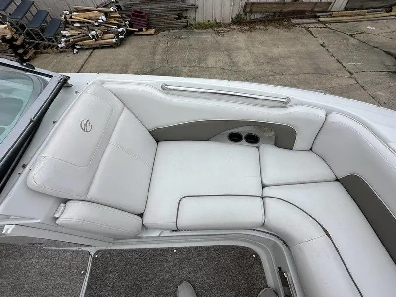 Slide: The Image of 2012 Crownline E1 boat interior with white cushioned seating and cup holders. - 7