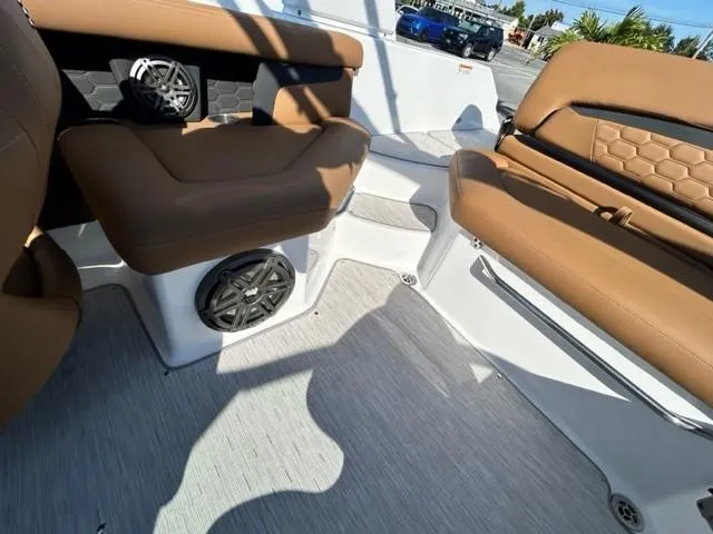 Slide: The Image of 2024 Four Winns HD3 OB boat interior with brown seating and built-in speakers. - 10