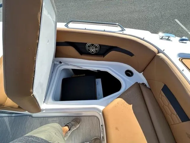 Slide: The Image of 2024 Four Winns HD3 OB boat interior storage compartment with tan seating. - 11