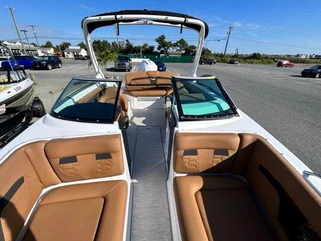 Slide: The Image of 2024 Four Winns HD3 OB boat with tan leather seats and open deck. - 13