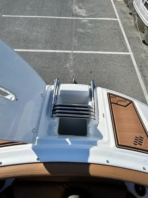 Slide: The Image of 2024 Four Winns HD3 OB boat with a retractable ladder and teak deck. - 14