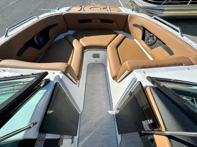 Slide: The Image of 2024 Four Winns HD3 OB boat interior with tan seating and open bow layout. - 15