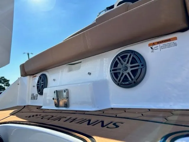 Slide: The Image of 2024 Four Winns HD3 OB boat with rear speakers and cushioned seating. - 18
