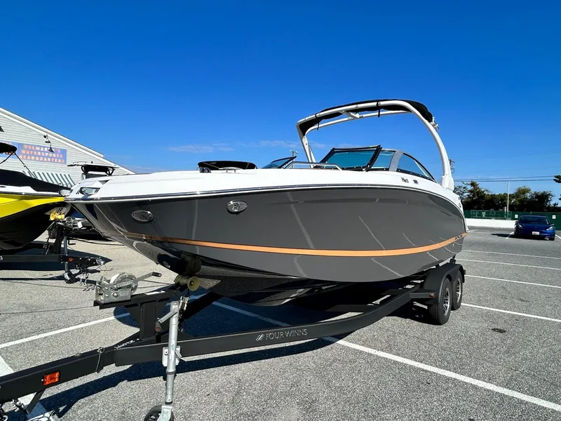 Slide: The Image of 2024 Four Winns HD3 OB boat on a trailer in a parking lot. - 21