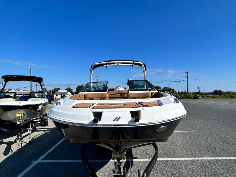 Slide: The Image of 2024 Four Winns HD3 OB boat in a parking lot under a clear blue sky. - 22