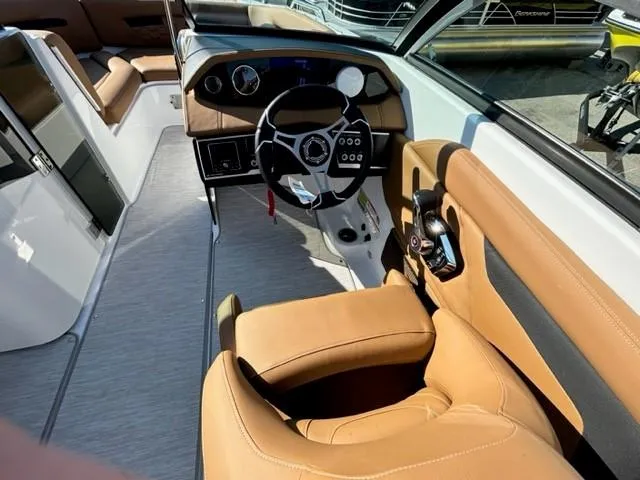 Slide: The Image of 2024 Four Winns HD3 OB boat interior with tan leather seats and modern dashboard. - 4