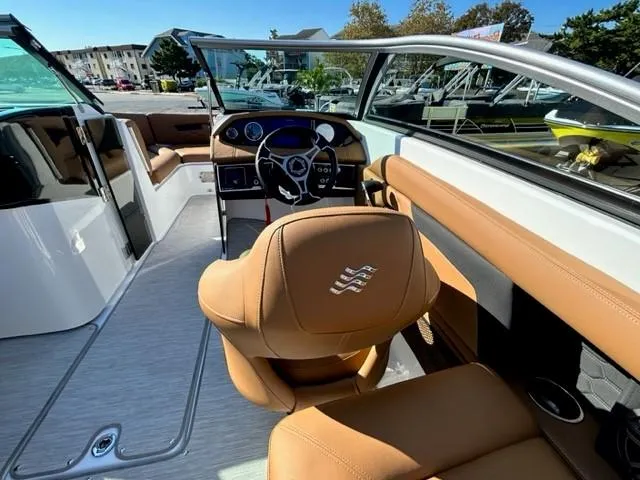 Slide: The Image of 2024 Four Winns HD3 OB boat interior with tan leather seats and modern dashboard. - 5