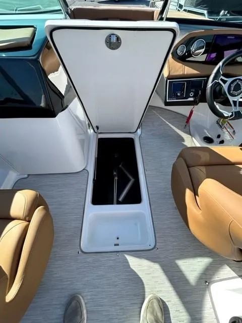 Slide: The Image of 2024 Four Winns HD3 OB boat interior with open storage compartment. - 7