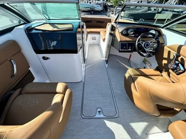 Slide: The Image of 2024 Four Winns HD3 OB boat interior with tan leather seats and modern dashboard. - 8