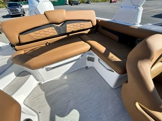 Slide: The Image of 2024 Four Winns HD3 OB boat interior with tan leather seating and white flooring. - 9