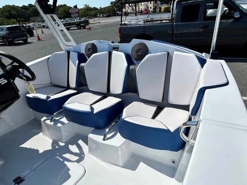 Slide: The Image of 2023 Scarab 165ID boat interior with blue and white seating. - 11