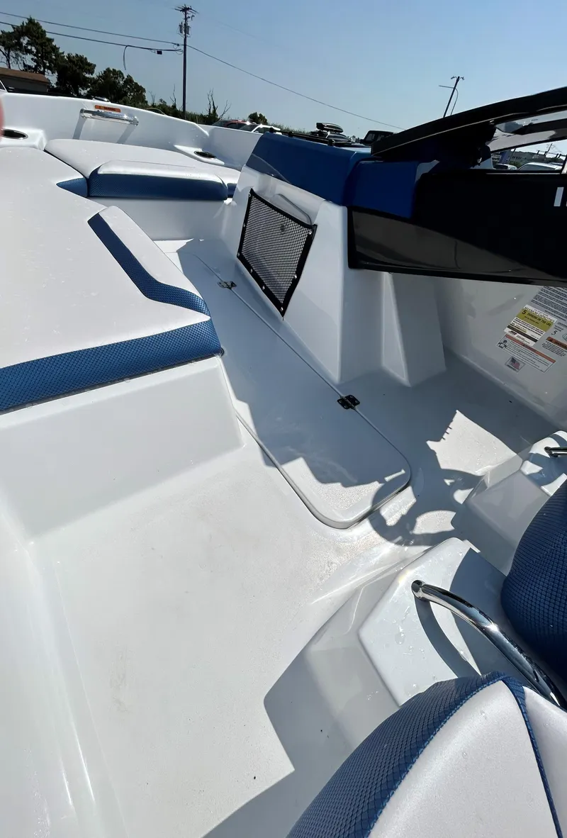 Slide: The Image of 2023 Scarab 165ID boat interior with blue and white seating. - 12