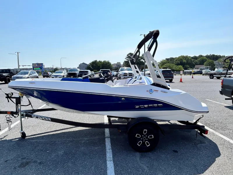 Slide: The Image of 2023 Scarab 165ID boat on a trailer in a parking lot. - 3