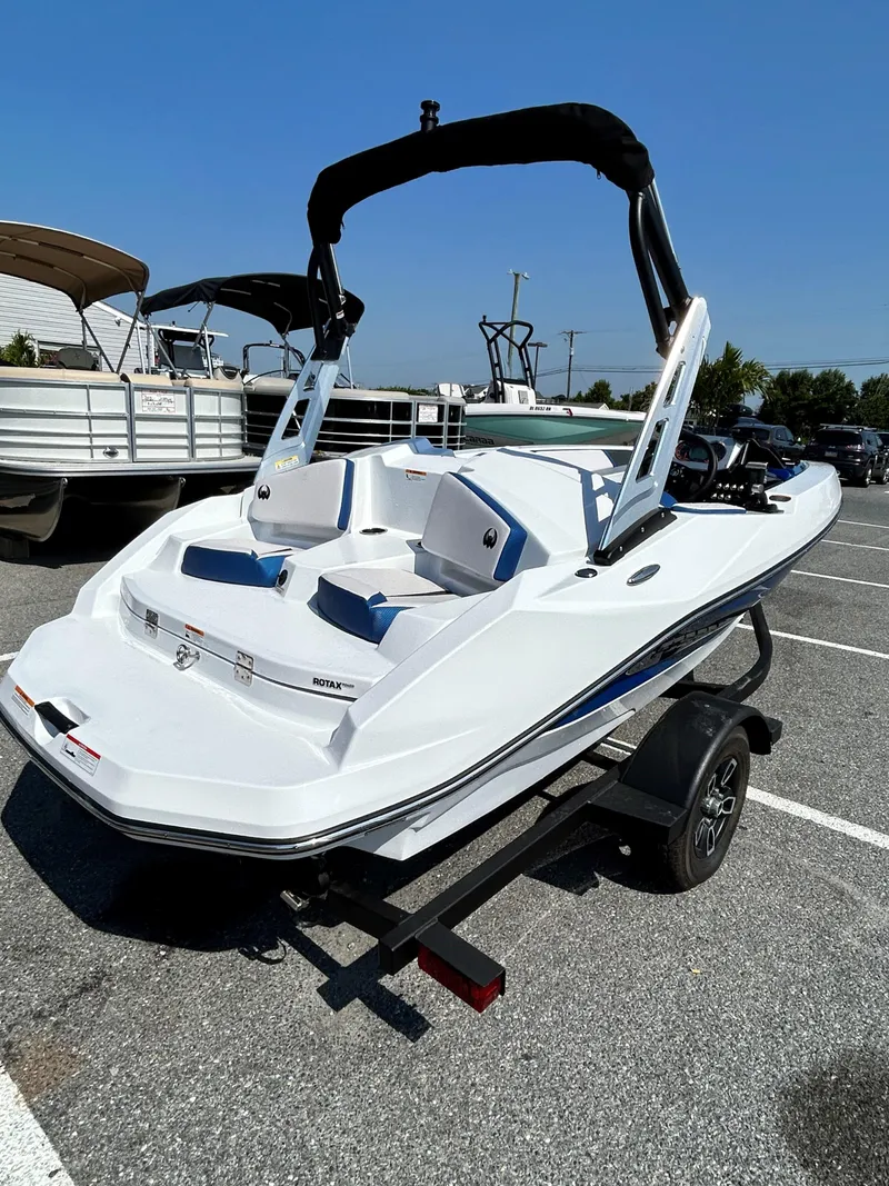 Slide: The Image of 2023 Scarab 165ID jet boat on trailer in parking lot. - 6
