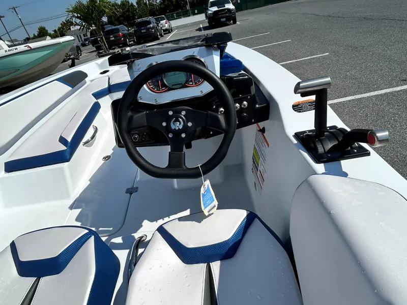 Slide: The Image of 2023 Scarab 165ID boat interior with steering wheel and seating. - 7