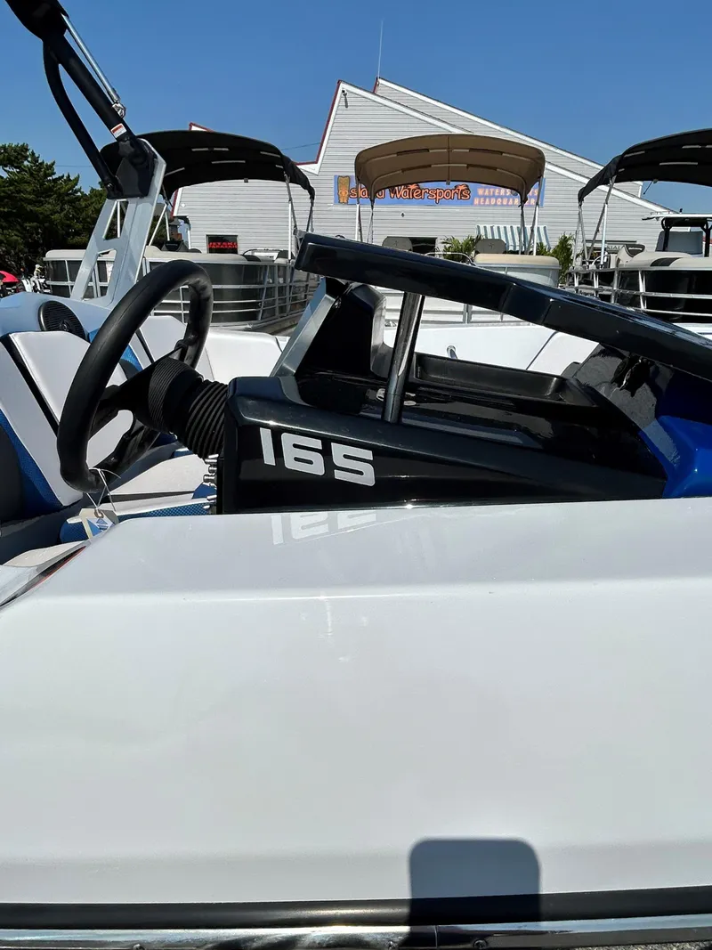 Slide: The Image of 2023 Scarab 165ID boat on display at a marina. - 8