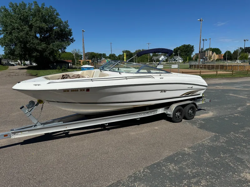 The Image of 1996 Sea Ray 260 Bow Rider on trailer in sunny outdoor setting. - 0