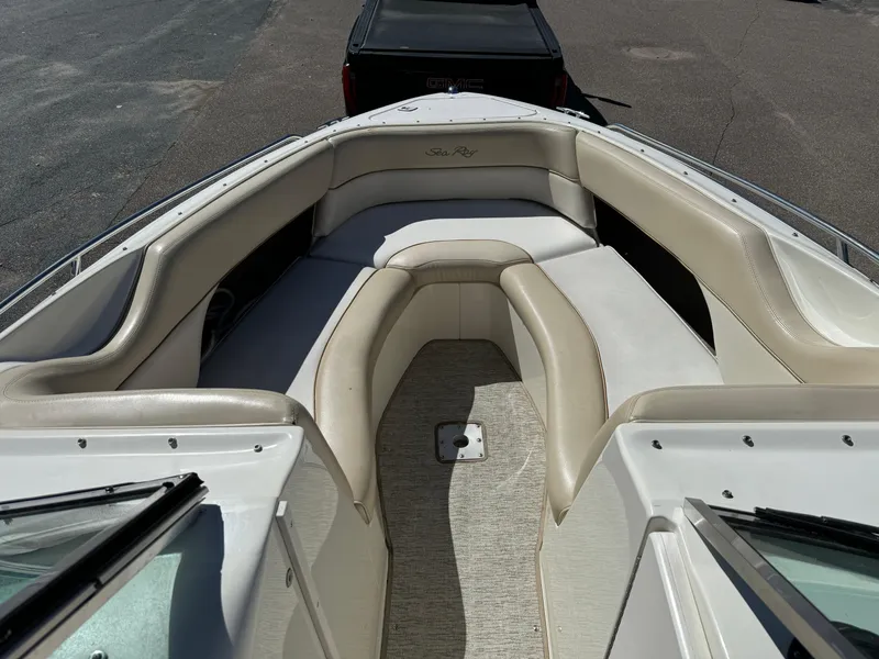 Slide: The Image of 1996 Sea Ray 260 Bow Rider boat with spacious seating and beige upholstery. - 13