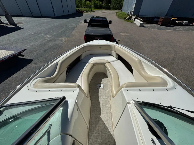 Slide: The Image of 1996 Sea Ray 260 Bow Rider boat with spacious seating, parked on a trailer. - 14