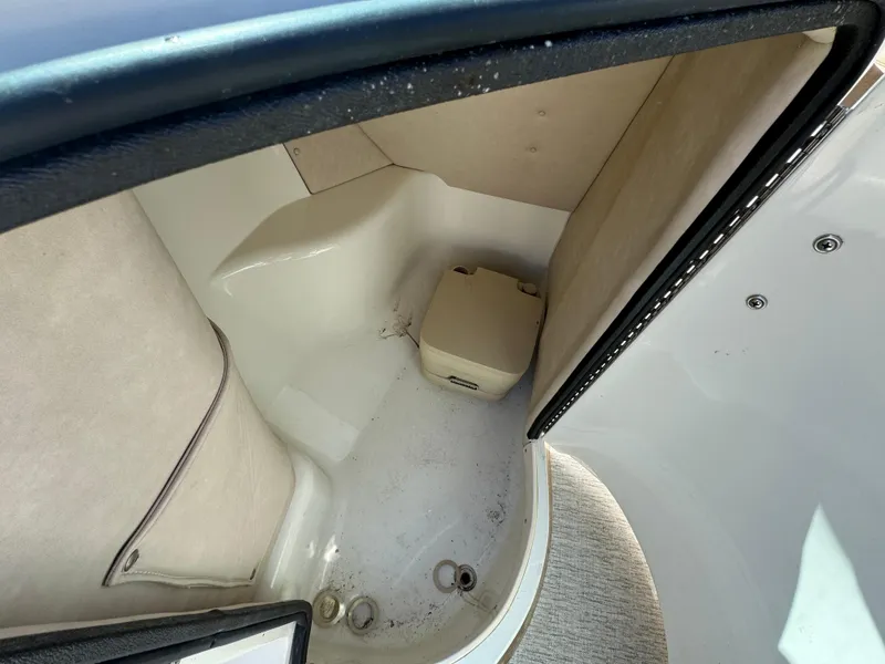 Slide: The Image of Interior of 1996 Sea Ray 260 Bow Rider boat, featuring compact restroom area. - 16