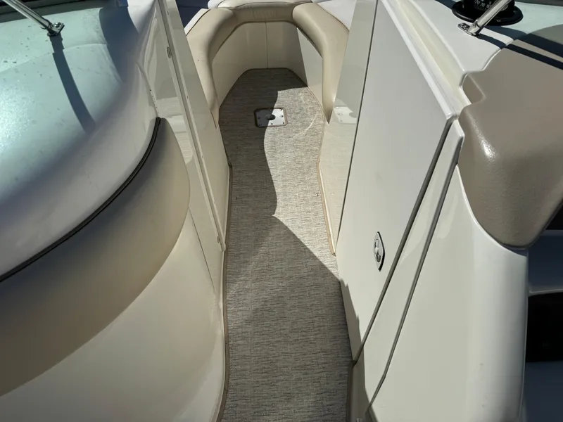 Slide: The Image of 1996 Sea Ray 260 Bow Rider interior with beige seating and carpeted floor. - 21