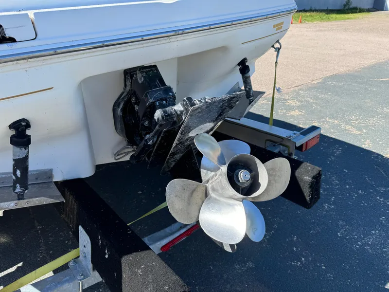 Slide: The Image of 1996 Sea Ray 260 Bow Rider boat propeller and stern on trailer. - 7