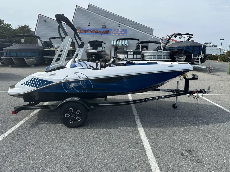 Slide: The Image of 2023 Scarab 165ID jet boat on trailer in parking lot. - 1