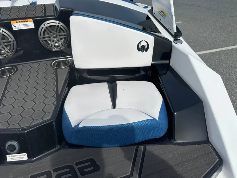Slide: The Image of 2023 Scarab 165ID boat interior seating with cup holders and speakers. - 10