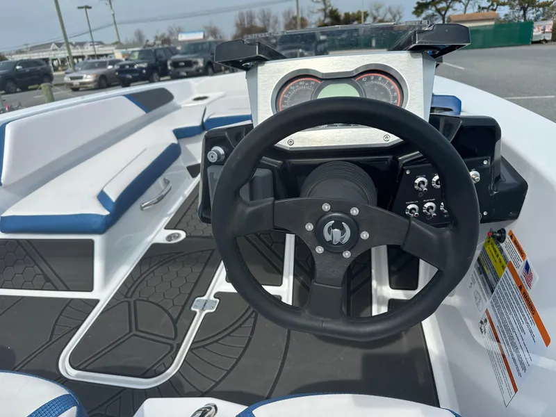 Slide: The Image of 2023 Scarab 165ID boat interior with steering wheel and dashboard. - 12