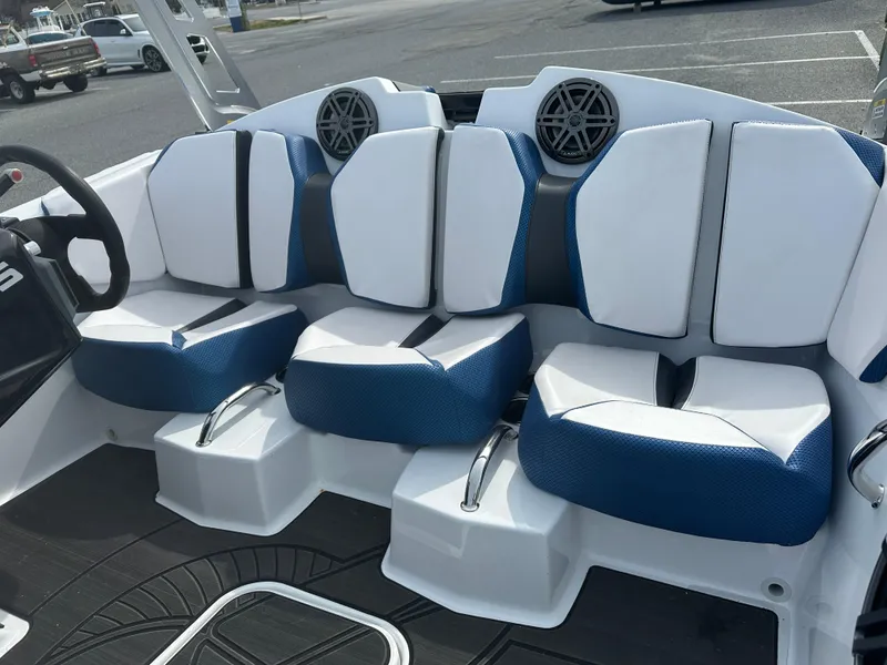 Slide: The Image of 2023 Scarab 165ID boat interior with white and blue seating. - 13