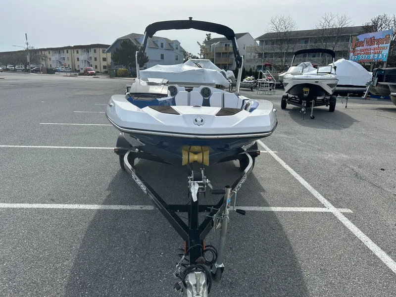 Slide: The Image of 2023 Scarab 165ID boat on a trailer in a parking lot. - 3