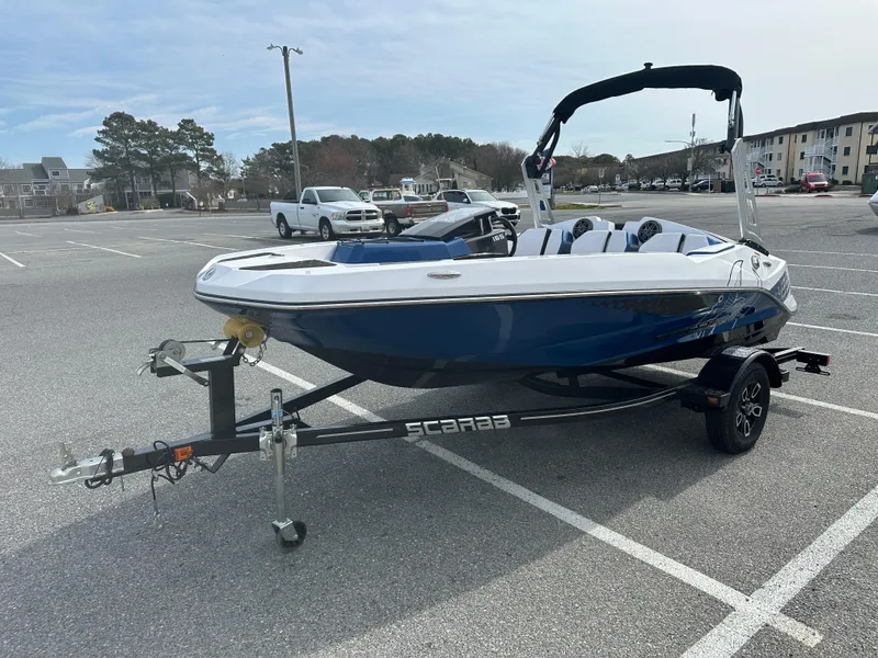 Slide: The Image of 2023 Scarab 165ID boat on a trailer in a parking lot. - 4