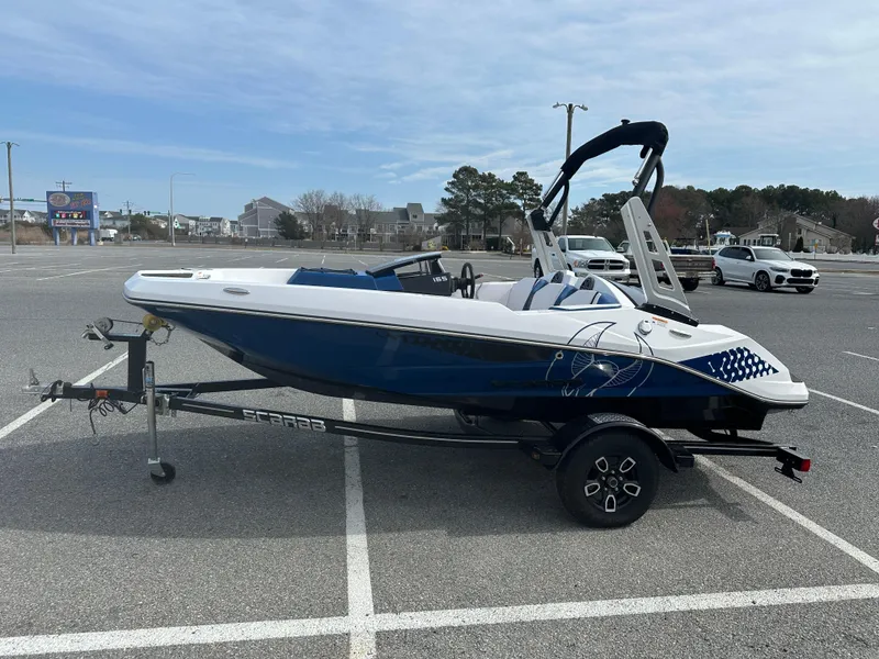 Slide: The Image of 2023 Scarab 165ID boat on trailer in parking lot. - 5
