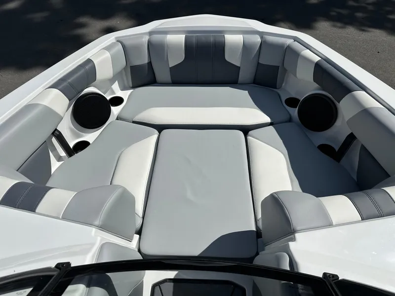 Slide: The Image of 2024 Malibu Wakesetter 21LXR boat interior with gray and white seating. - 3