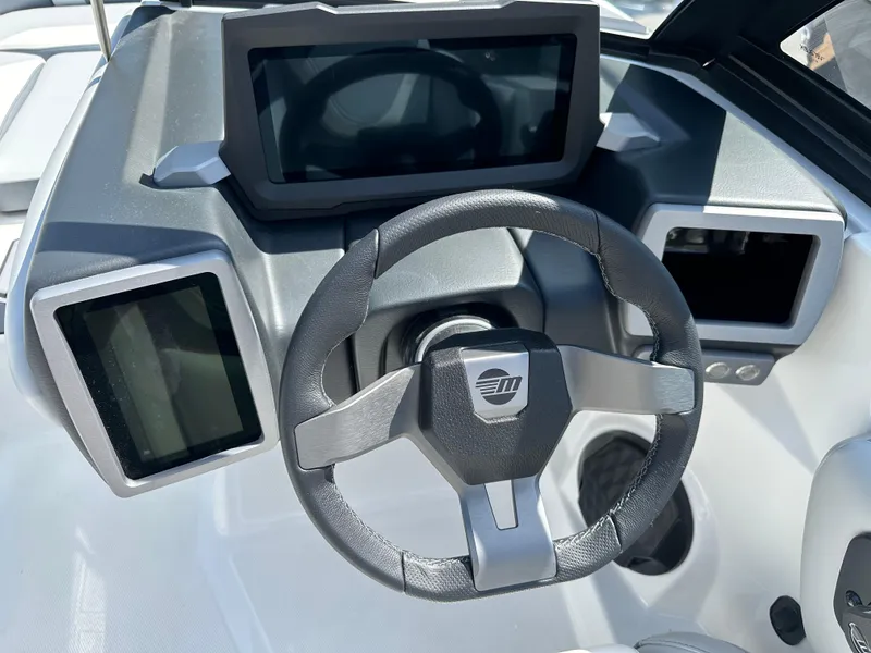 Slide: The Image of 2024 Malibu Wakesetter 21LXR dashboard with steering wheel and digital displays. - 4